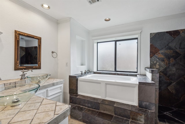 bathroom featuring ornamental molding, a bathing tub, and vanity