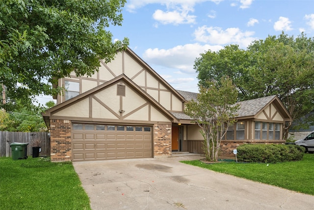 tudor home featuring a front lawn and a garage