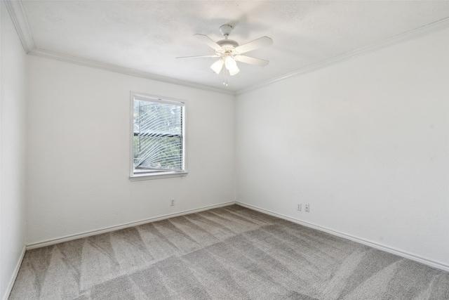 carpeted empty room with ornamental molding and ceiling fan