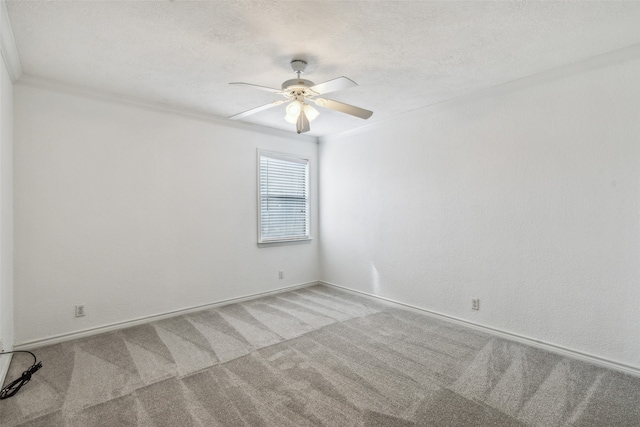 carpeted empty room with ornamental molding, a textured ceiling, and ceiling fan