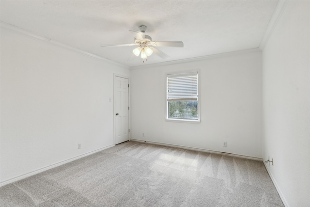 empty room with light carpet, crown molding, and ceiling fan