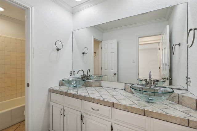 bathroom featuring ornamental molding, tile patterned floors, and vanity