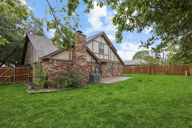 back of house with a yard, a patio area, and central AC