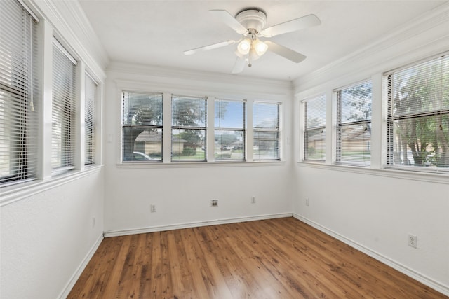 unfurnished sunroom featuring ceiling fan