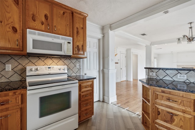 kitchen with white appliances, backsplash, a notable chandelier, ornamental molding, and hardwood / wood-style flooring