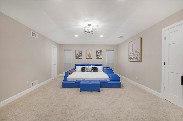 bedroom with carpet floors and a chandelier