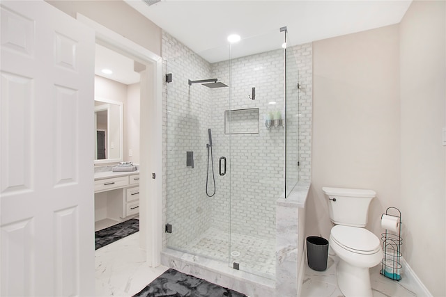 bathroom with walk in shower, vanity, and toilet