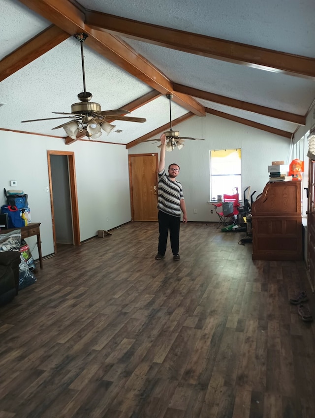 living room featuring ceiling fan, vaulted ceiling with beams, a textured ceiling, and dark wood-type flooring