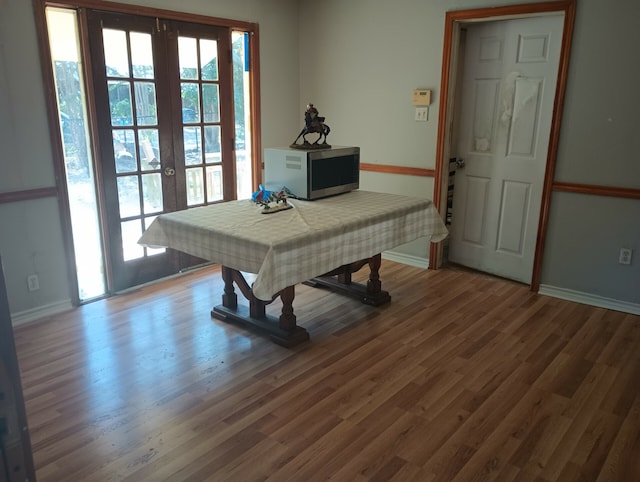 interior space with hardwood / wood-style floors and french doors