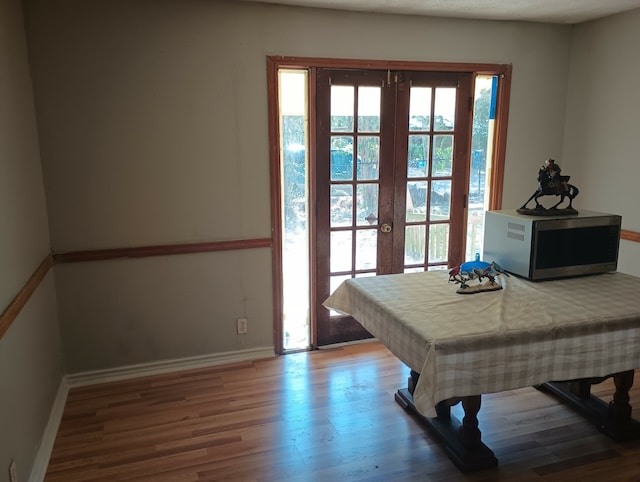 game room with french doors, hardwood / wood-style floors, and a wealth of natural light