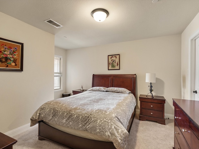 carpeted bedroom with a textured ceiling