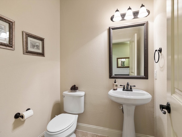 bathroom featuring tile patterned floors and toilet