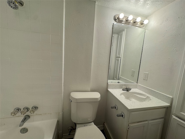 bathroom with vanity, a textured ceiling, and toilet