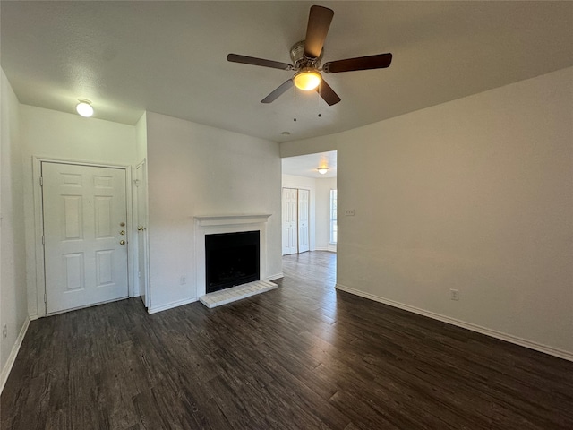 unfurnished living room with ceiling fan and dark hardwood / wood-style flooring