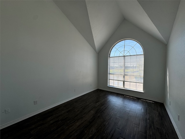 unfurnished room with vaulted ceiling and dark hardwood / wood-style floors