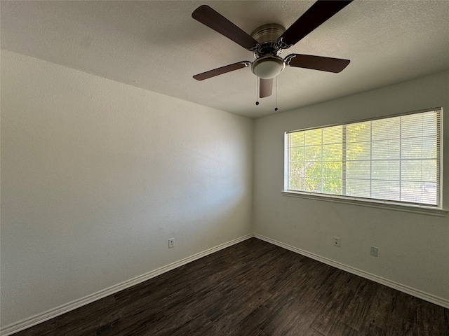 unfurnished room with a textured ceiling, dark wood-type flooring, and ceiling fan