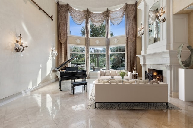 living room with a high ceiling and a premium fireplace