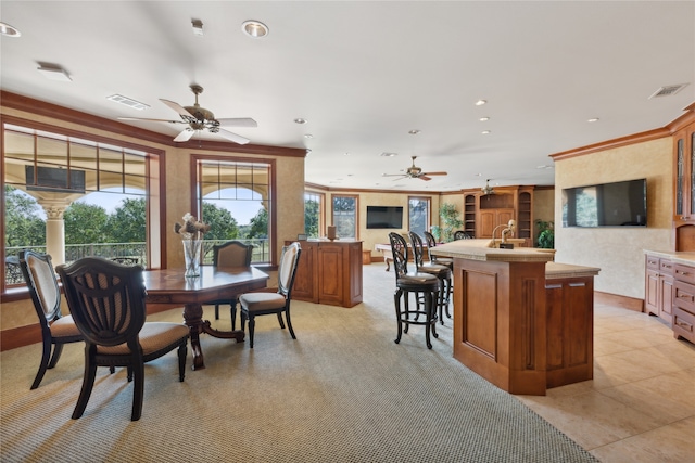 dining room with ceiling fan, sink, and light tile patterned floors