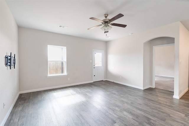 empty room with ceiling fan and dark wood-type flooring