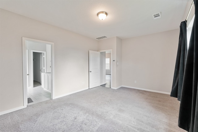 unfurnished bedroom featuring light carpet