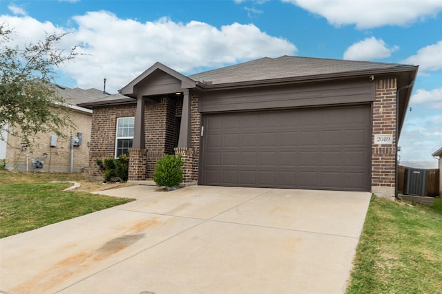 single story home featuring cooling unit, a garage, and a front lawn