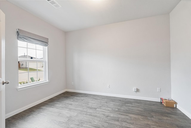 empty room with dark hardwood / wood-style flooring