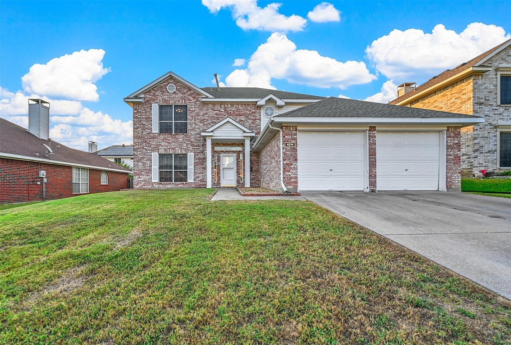 front facade with a front lawn and a garage