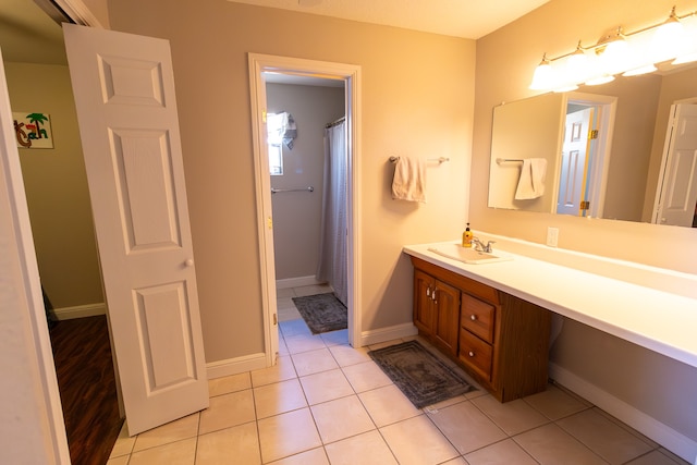 bathroom with tile patterned flooring, curtained shower, and vanity