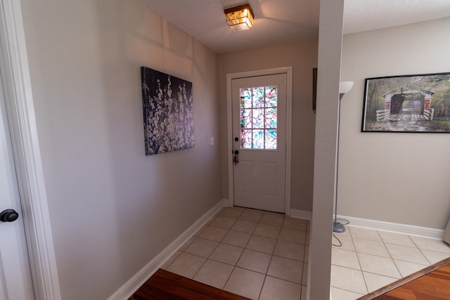 doorway with light tile patterned floors