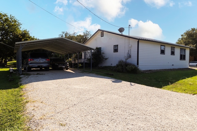 view of parking featuring a yard and a carport