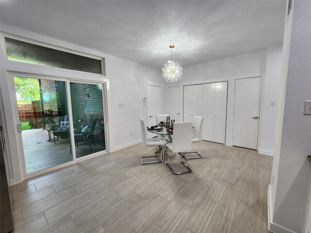 dining room featuring a notable chandelier and a textured ceiling