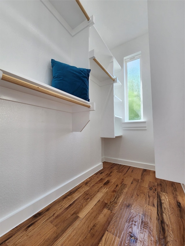 walk in closet with hardwood / wood-style floors