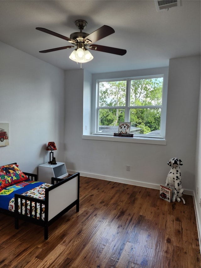 bedroom featuring ceiling fan and dark hardwood / wood-style floors