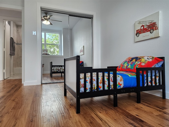 bedroom featuring ceiling fan, a closet, and wood-type flooring