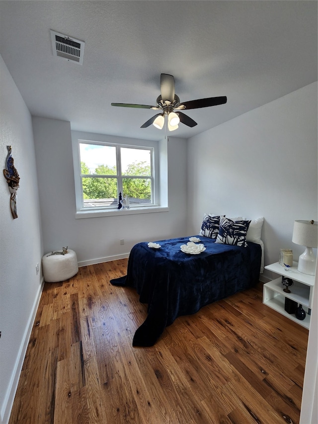 bedroom with hardwood / wood-style flooring and ceiling fan