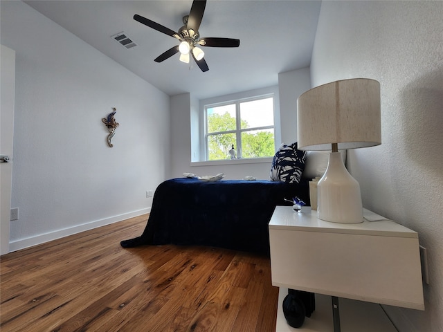 bedroom with ceiling fan and dark hardwood / wood-style floors