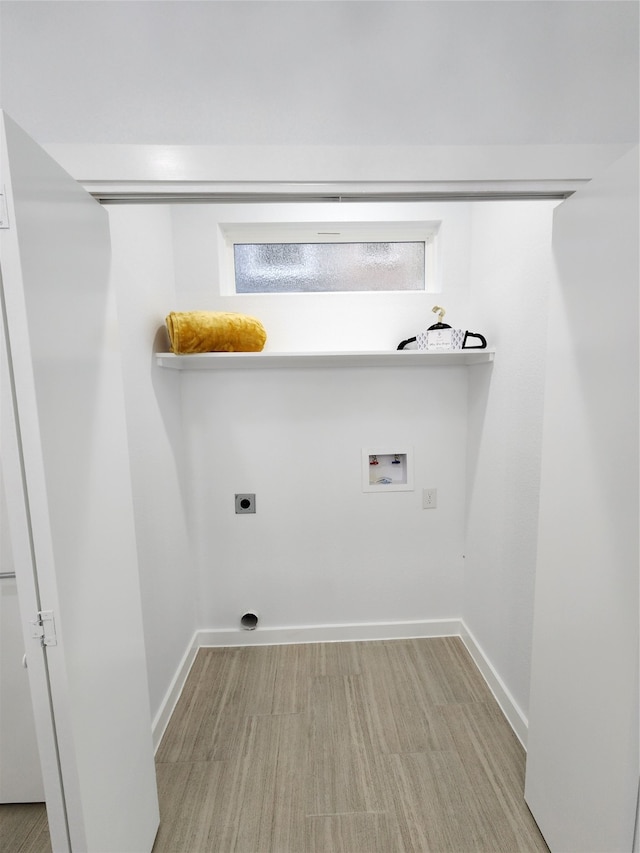 laundry room featuring hookup for a washing machine, light hardwood / wood-style floors, and hookup for an electric dryer