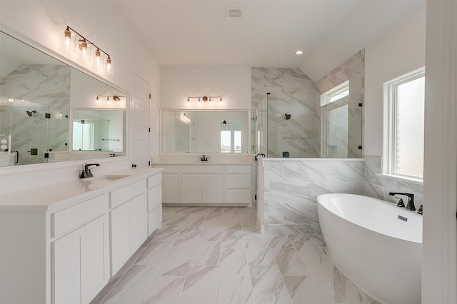 bathroom featuring separate shower and tub, vanity, and tile walls