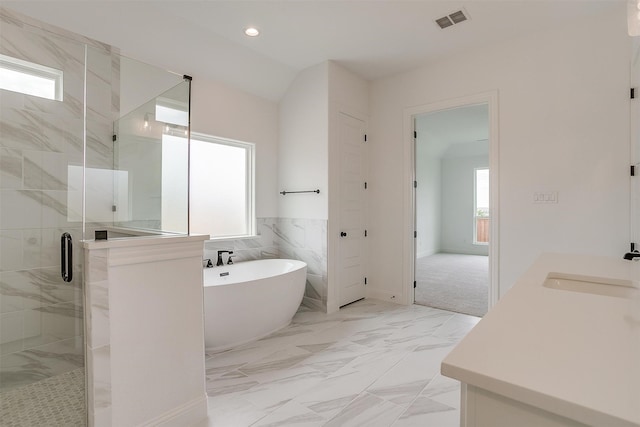 bathroom featuring vanity, shower with separate bathtub, tile walls, and plenty of natural light