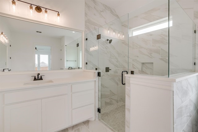 bathroom with walk in shower and vanity