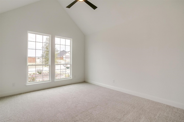 spare room featuring carpet floors, high vaulted ceiling, and ceiling fan