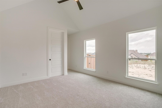 empty room featuring light carpet, high vaulted ceiling, and ceiling fan