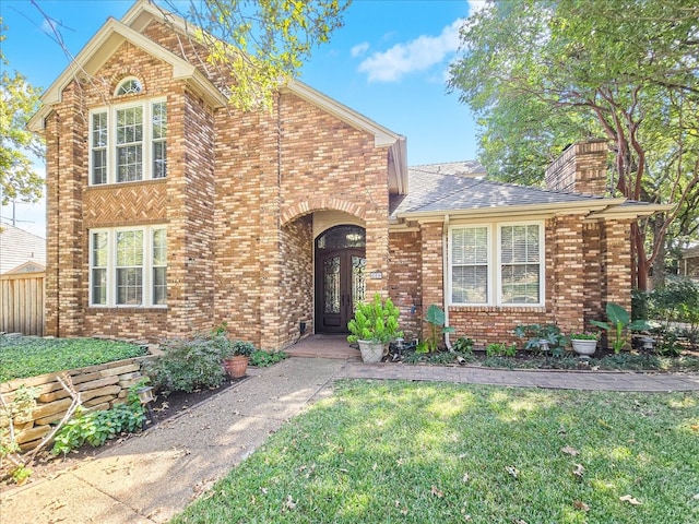 view of front facade featuring french doors and a front lawn