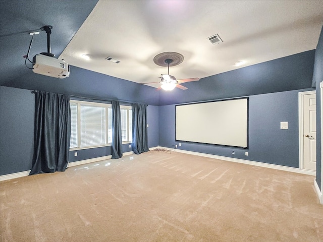 cinema with ceiling fan and light carpet