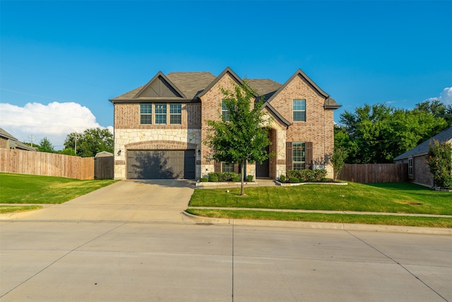 view of front of property featuring a garage and a front yard