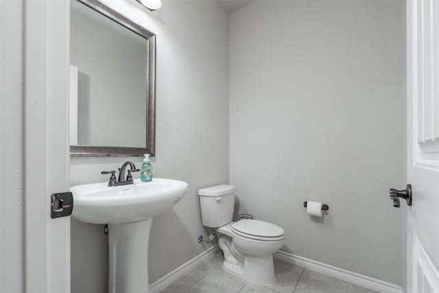 bathroom with tile patterned floors, toilet, and sink