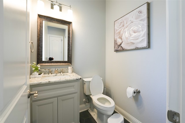 bathroom featuring tile patterned floors, toilet, and vanity