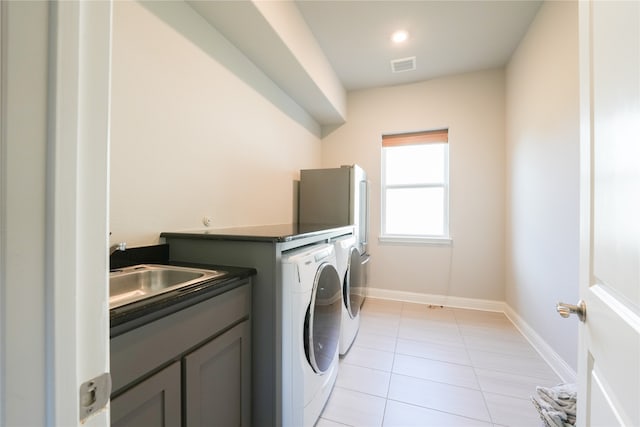 laundry area featuring light tile patterned floors, sink, and independent washer and dryer