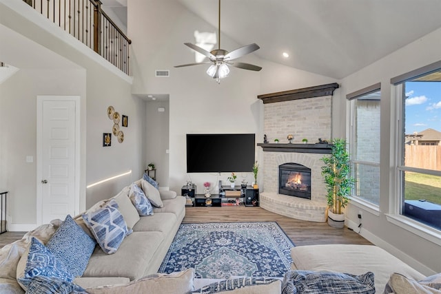 2104 Devonblue Dr, Forney, TX 75126 - living room with a ceiling fan, vaulted ceiling, a fireplace, wood finished floors, and baseboards