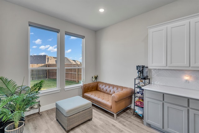 sitting room with light wood-style floors, recessed lighting, and baseboards